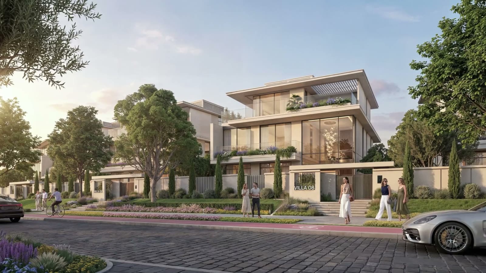 Street of contemporary villas with landscaped front gardens at sunset