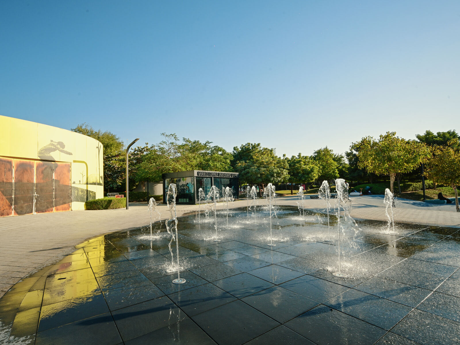 Water feature plaza with open air seating at Aljada
