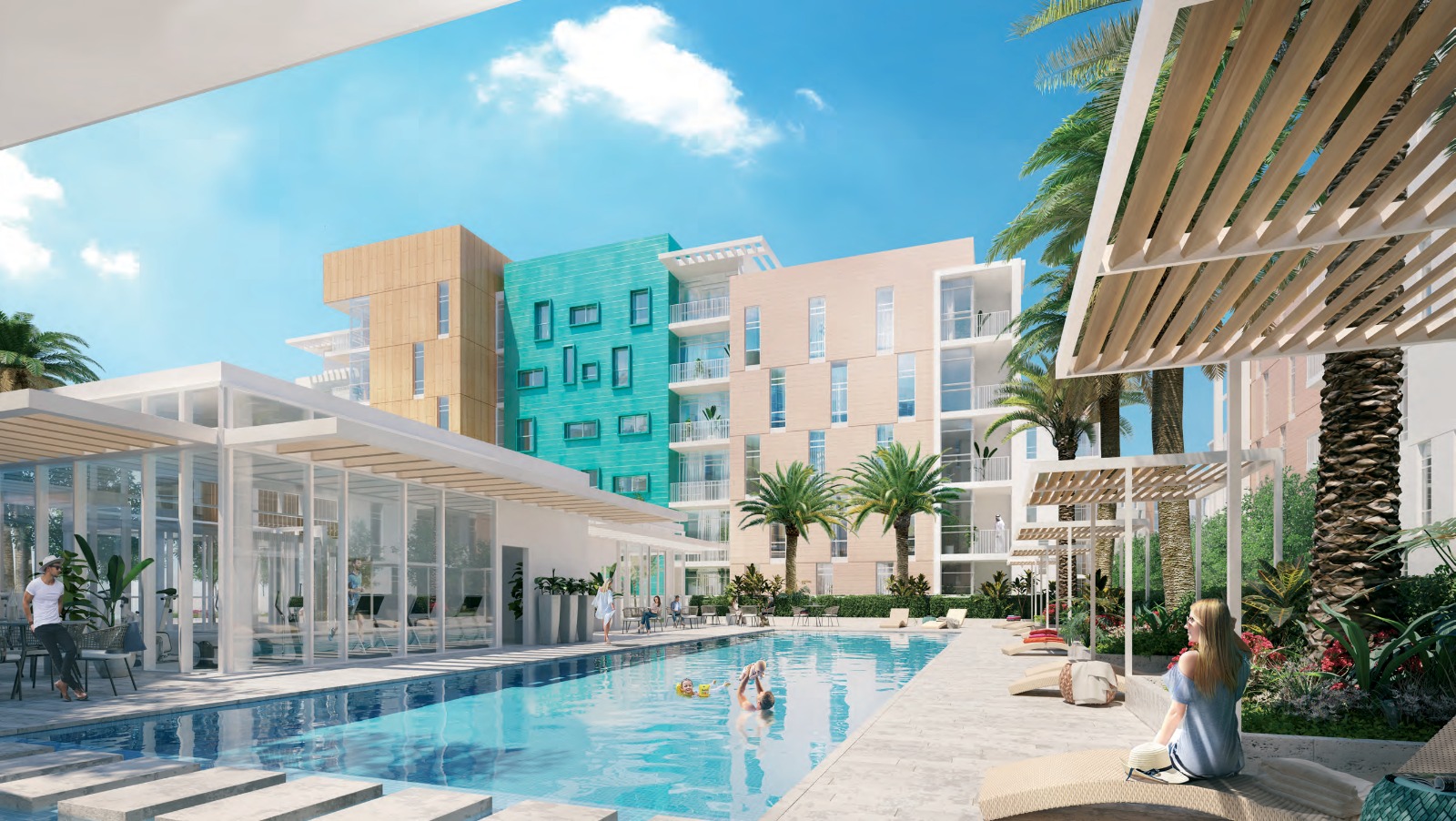 Swimming pool surrounded by palms and apartment buildings at Uptown Zahia, Sharjah