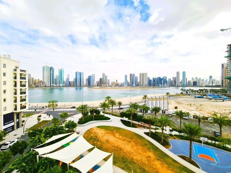 Landscaped park with play areas and lawns beside the water at Maryam Island