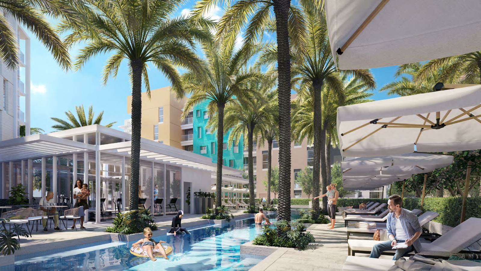 Swimming pool with sun loungers and palm trees between apartment buildings at Uptown Zahia