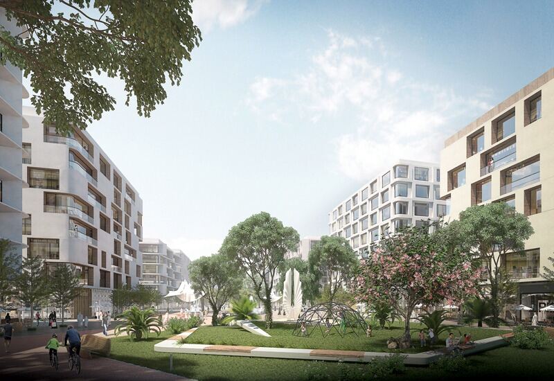 Residential park with play equipment and cycle path at Aljada
