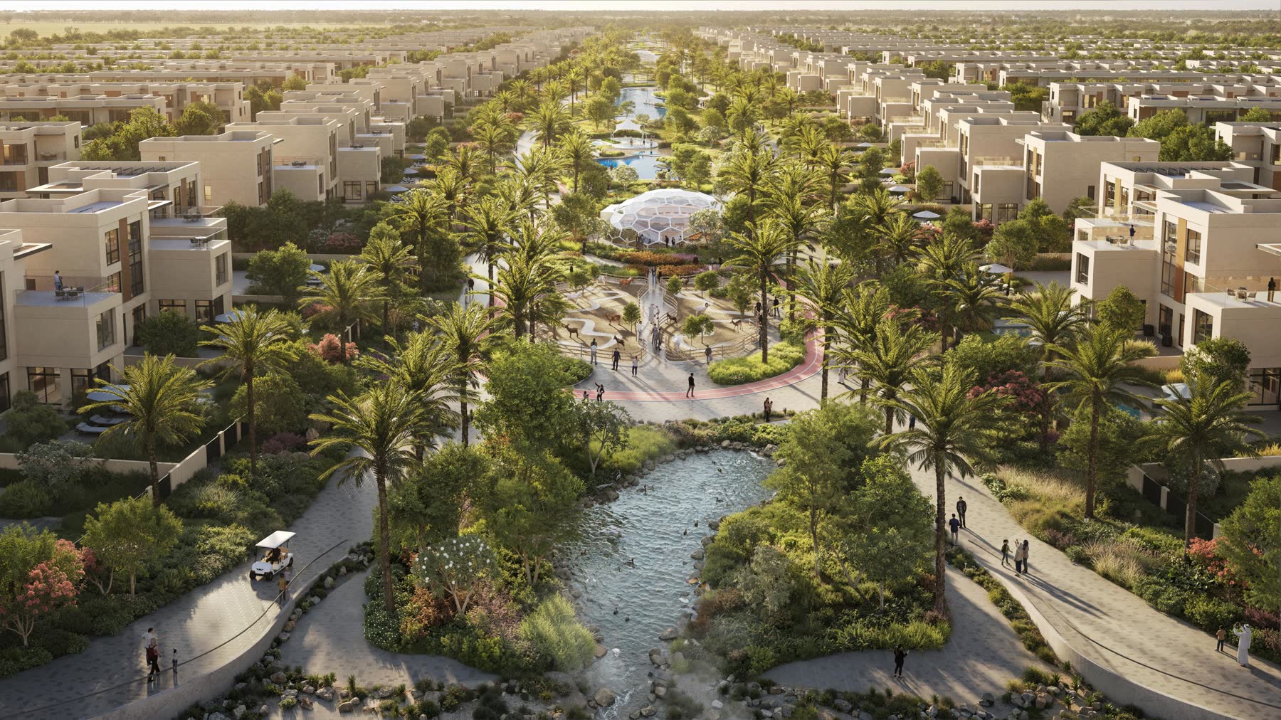 Landscaped green spine of parks and shaded walkways running through Sharjah Sustainable City II