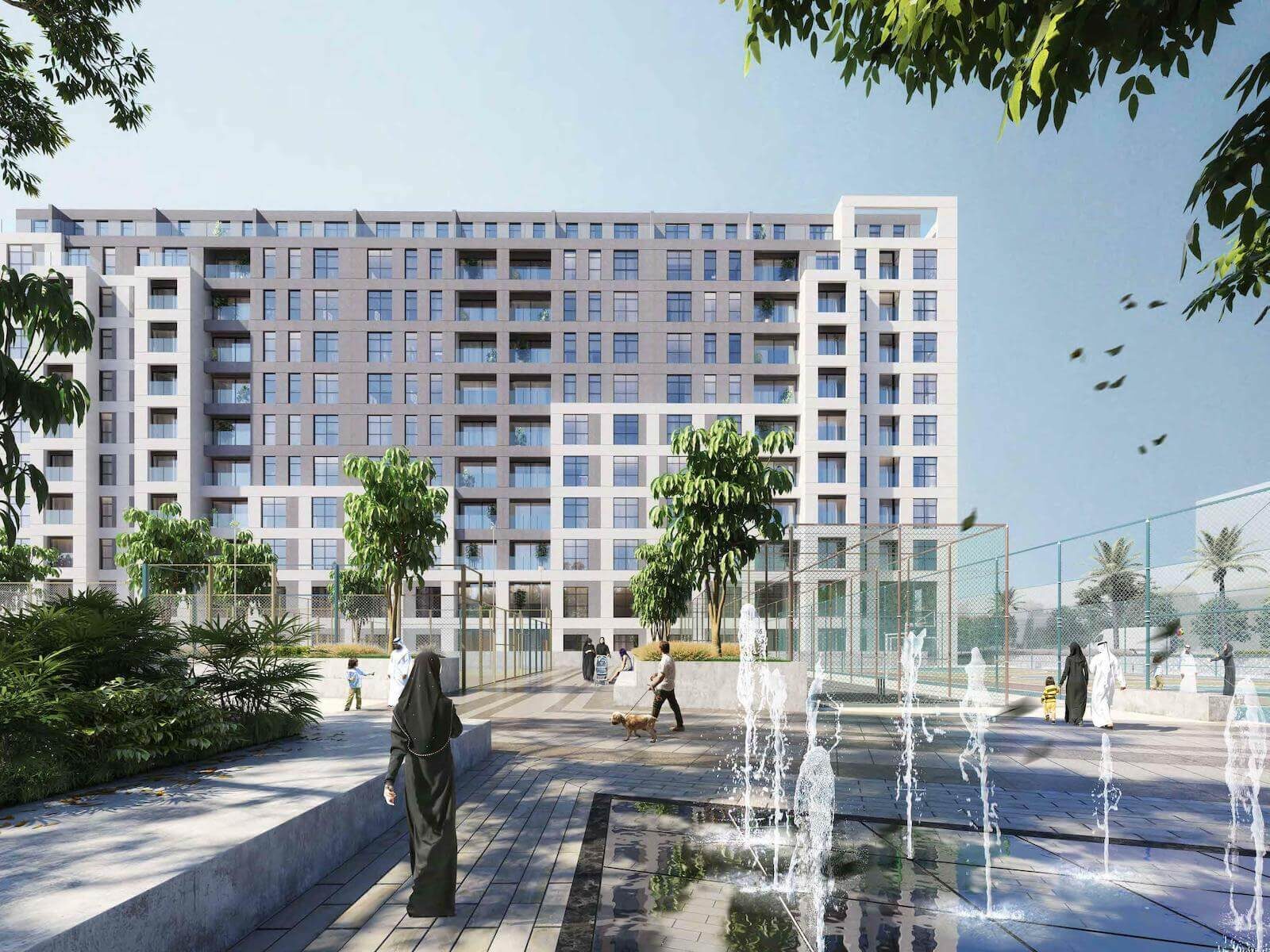 Fountain plaza and planted gardens in front of apartments at Al Mamsha