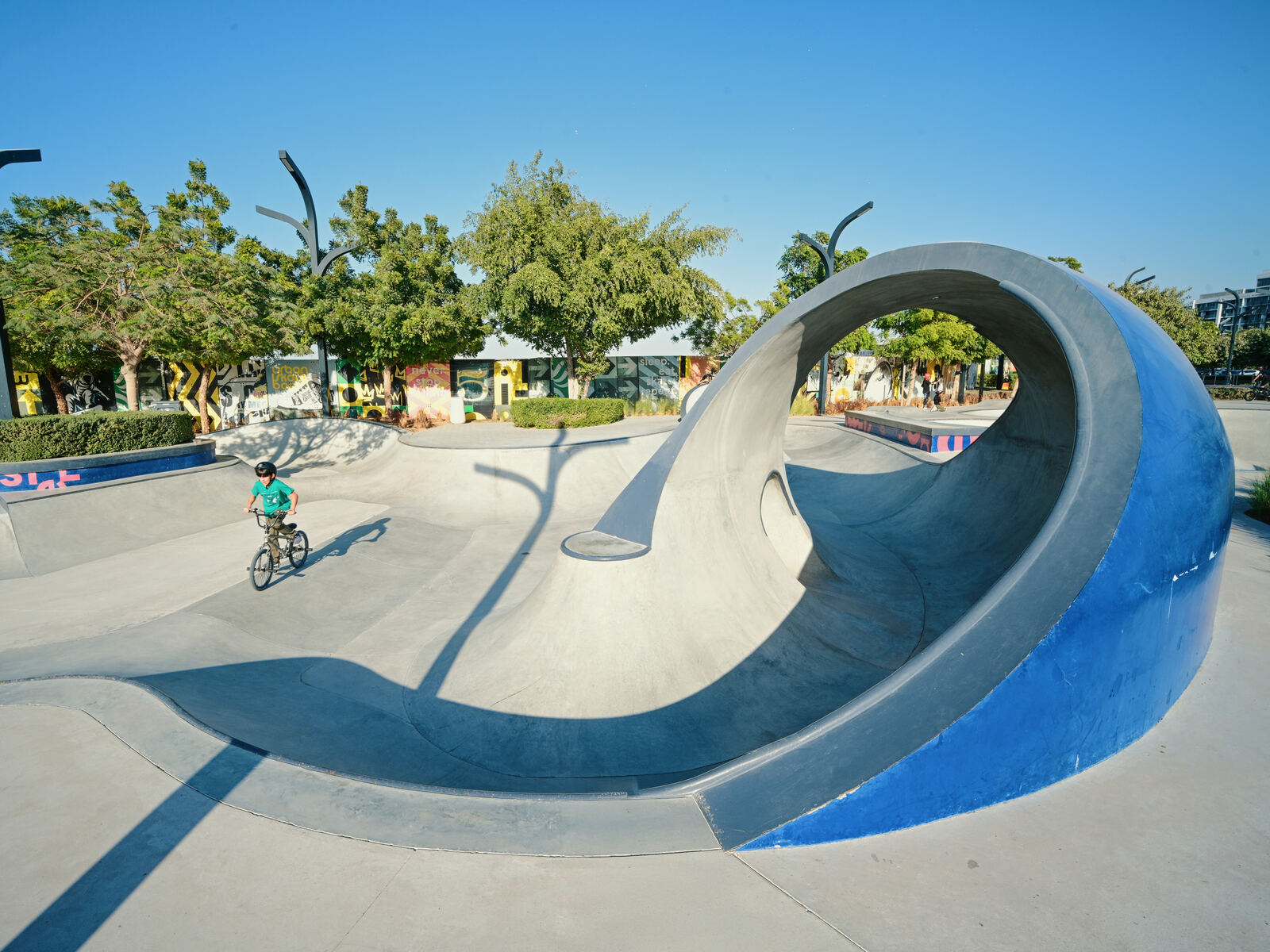 Concrete skate bowl with a rider at Madar, Aljada