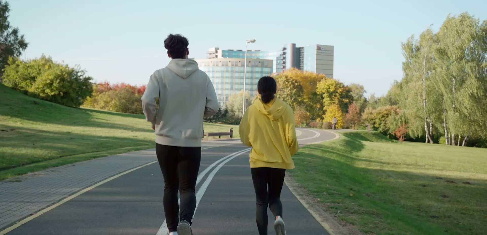 Two residents jogging along a landscaped running track at Hayyan